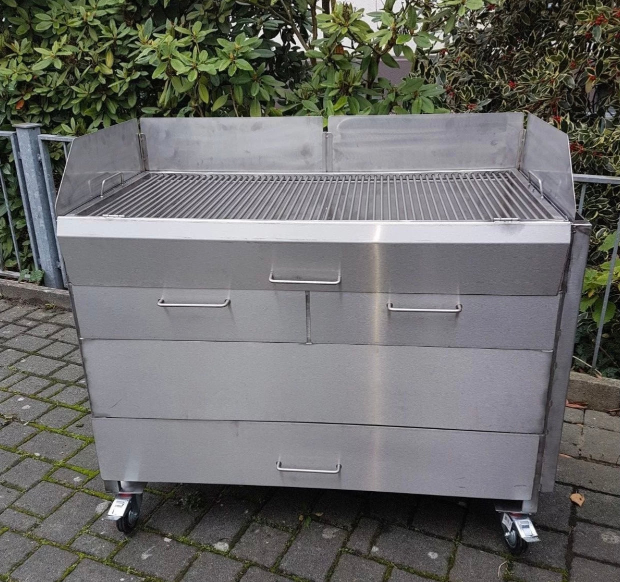 Großer Holzkohlegrill Edelstahl mieten mit Rollen und Windschutz, ideal für Outdoor-Grillfeste